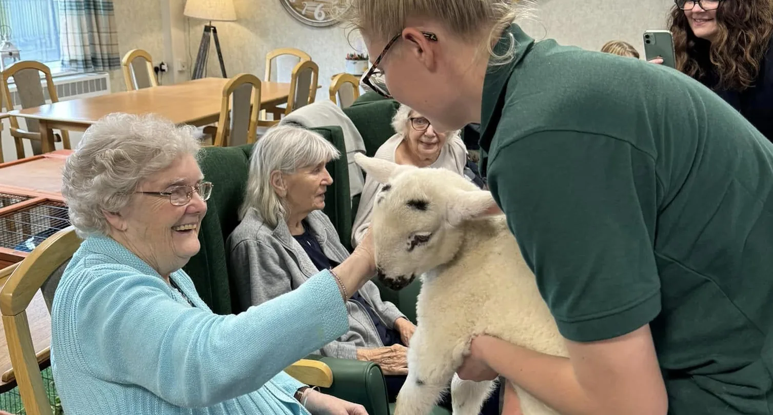 A resident enjoying a gentle animal encounter
