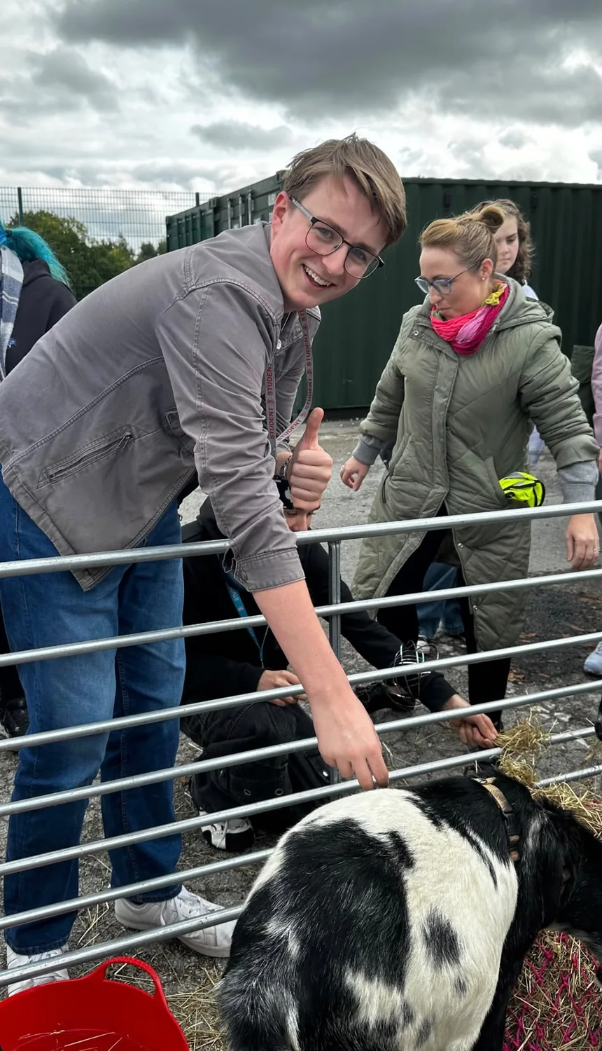 St John Rigby college visitors meeting two pygmy goats